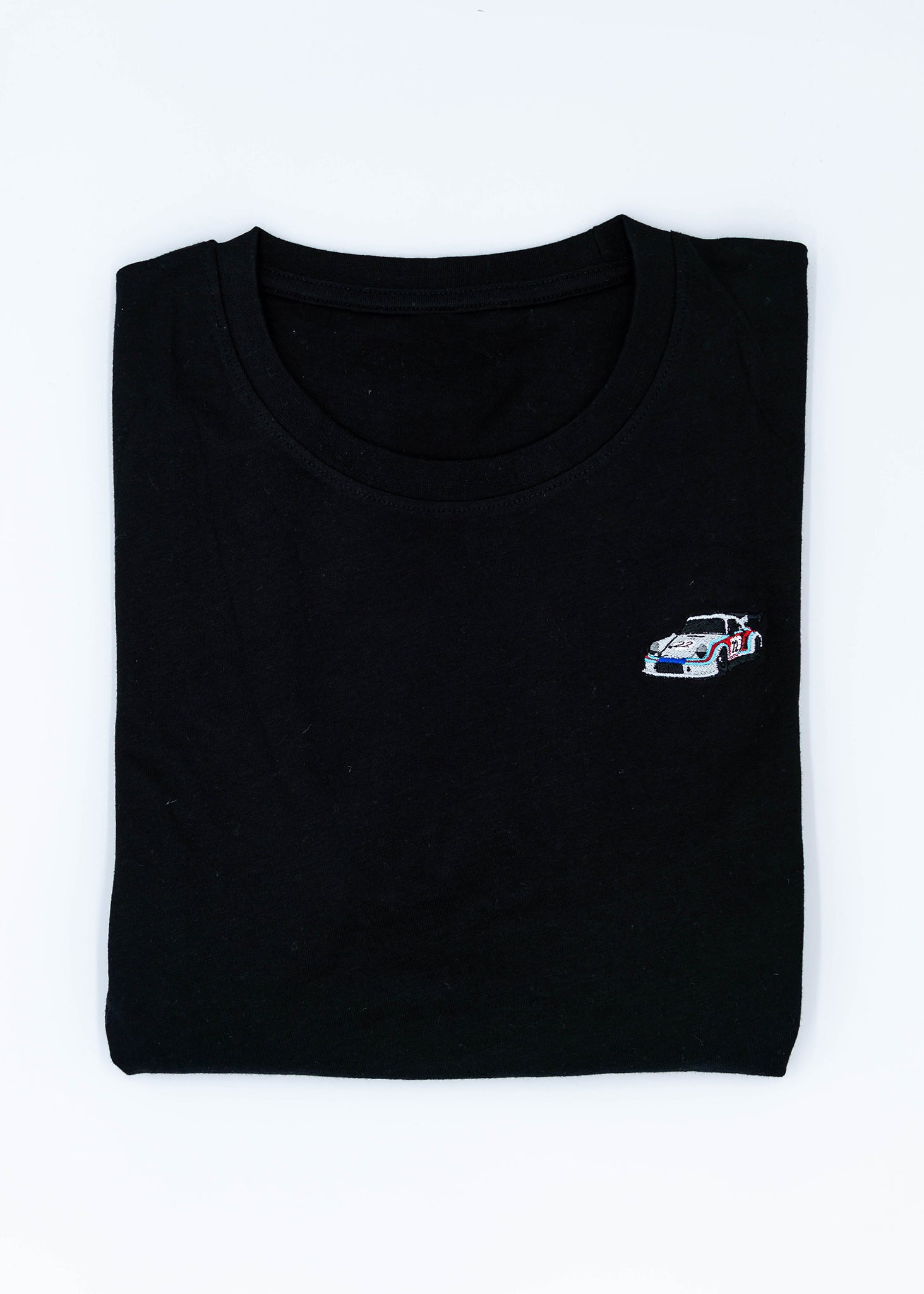 A black 911 RSR 2.1 Turbo T-Shirt for men. Photo is a front view of the shirt with an embroidered 911 RSR 2.1 Turbo. Fabric composition is 65% polyester, and 35% cotton. The material is very stretchy, soft, comfortable, breathable, and non-transparent. The style of this shirt is short sleeve, with a crewneck neckline.