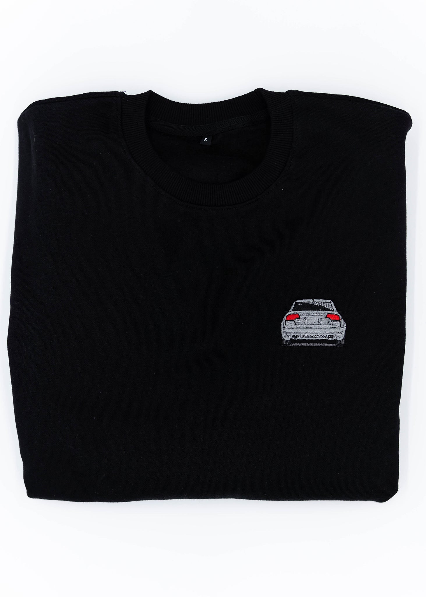 A black B7 RS4 crewneck sweater for men. Photo is a close up view of the sweater with an embroidered B7 RS4. Fabric is a cotton and polyester mix and high quality and fits to size. The style is long sleeve, crew neck, and embroidery on left chest.