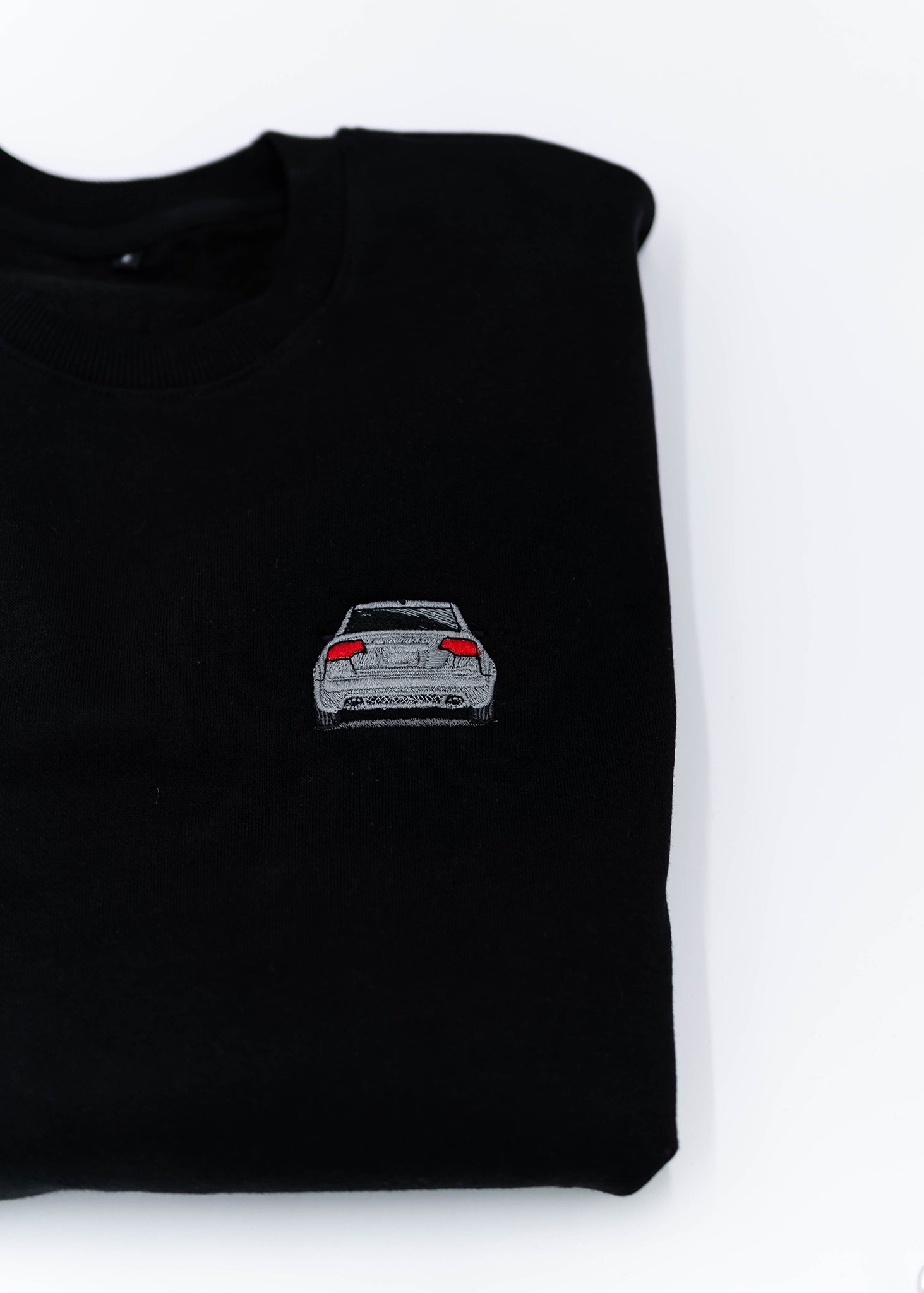 A black B7 RS4 crewneck sweater for men. Photo is a close up view of the sweater with an embroidered B7 RS4. Fabric is a cotton and polyester mix and high quality and fits to size. The style is long sleeve, crew neck, and embroidery on left chest.