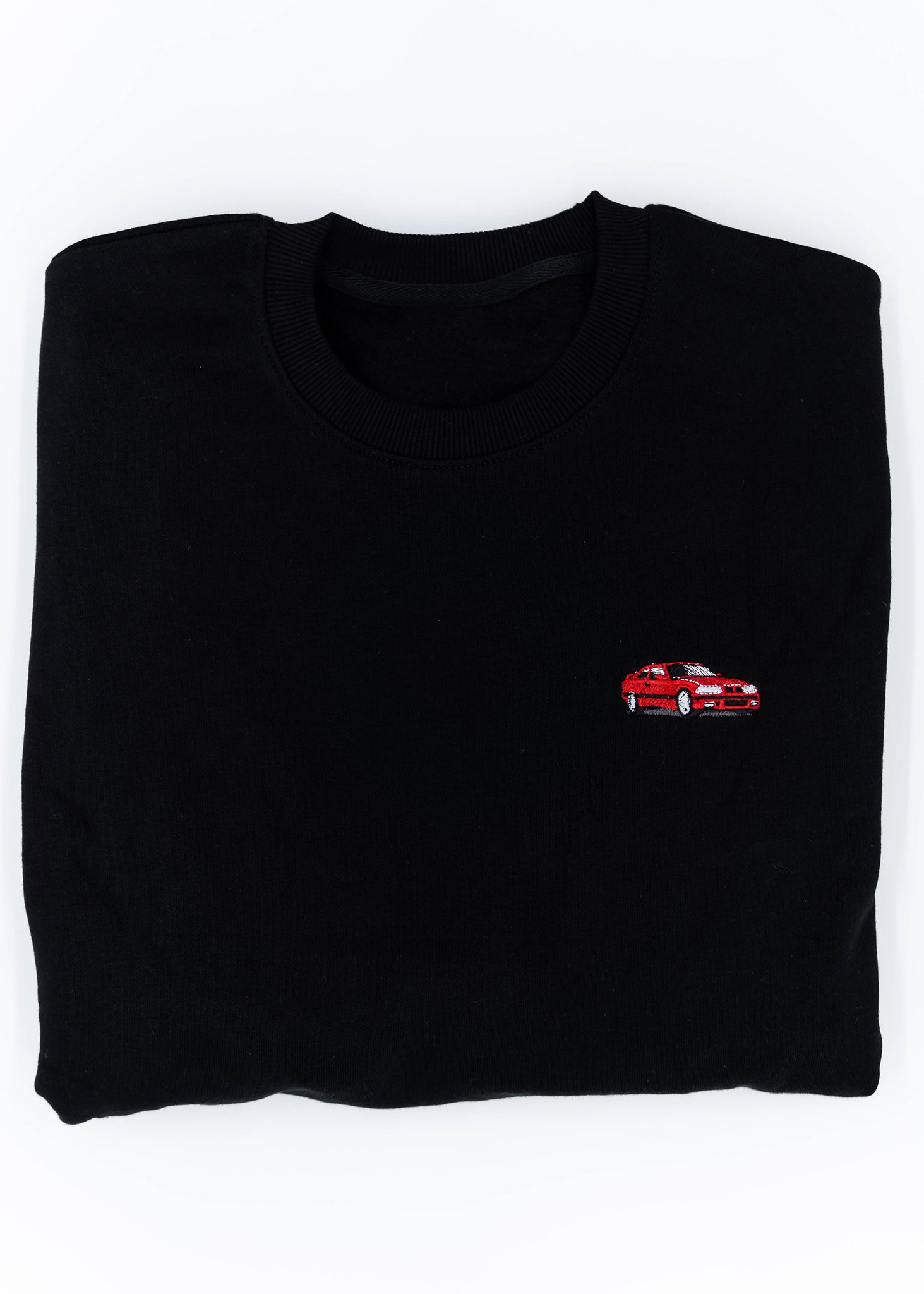 A black E36 M3 crewneck sweater for men. Photo is a close up view of the sweater with an embroidered E36 M3. Fabric is a cotton and polyester mix and high quality and fits to size. The style is long sleeve, crew neck, and embroidery on left chest.