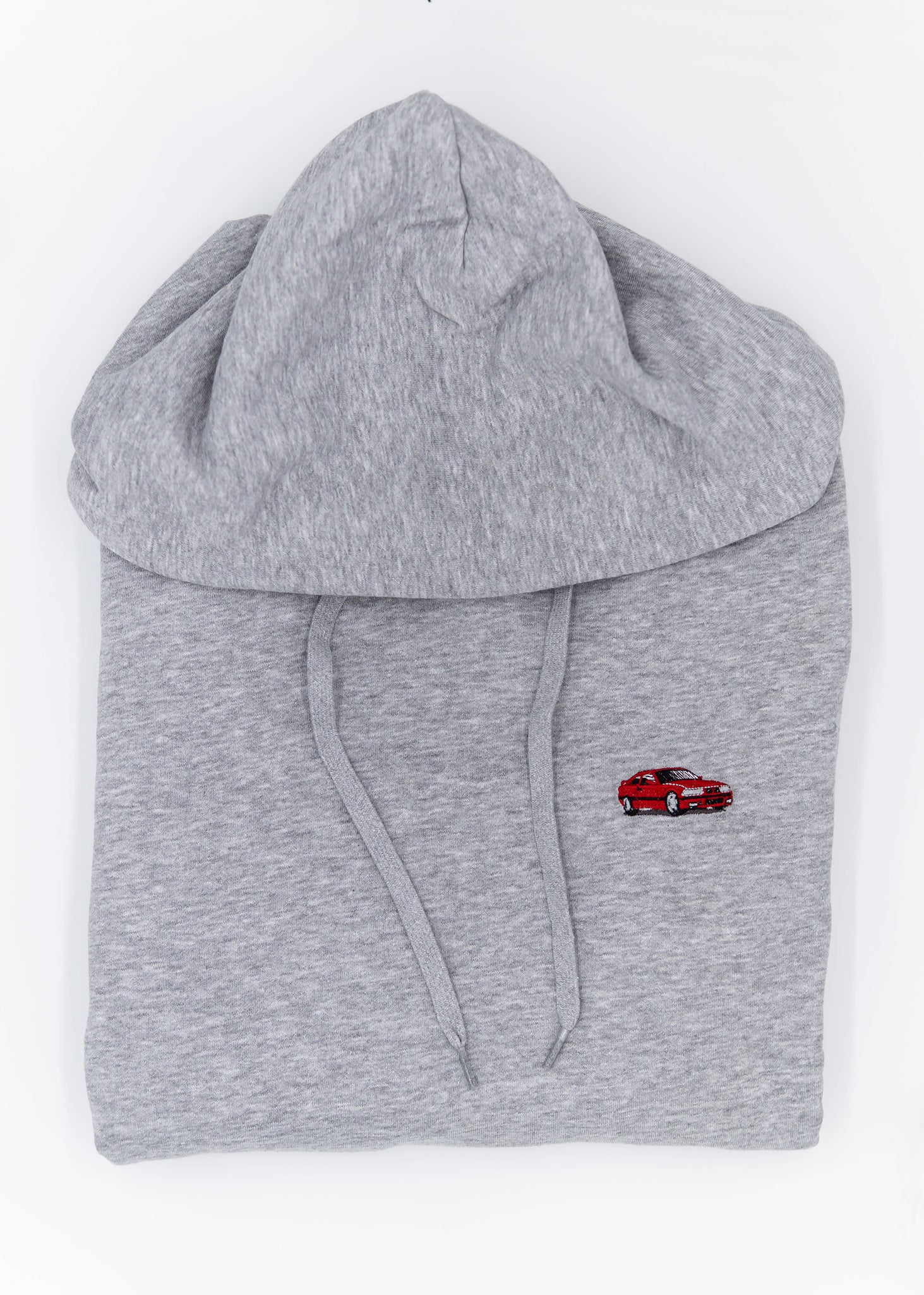 A grey E36 M3 unisex hoodie for men and women. Photo is a close up view of the sweater with an embroidered red E36 M3. Fabric composition is cotton, polyester, and rayon. The material is very soft, stretchy, and non-transparent. The style of this hoodie is long sleeve, crewneck with a hood, hooded, with embroidery on the left chest.