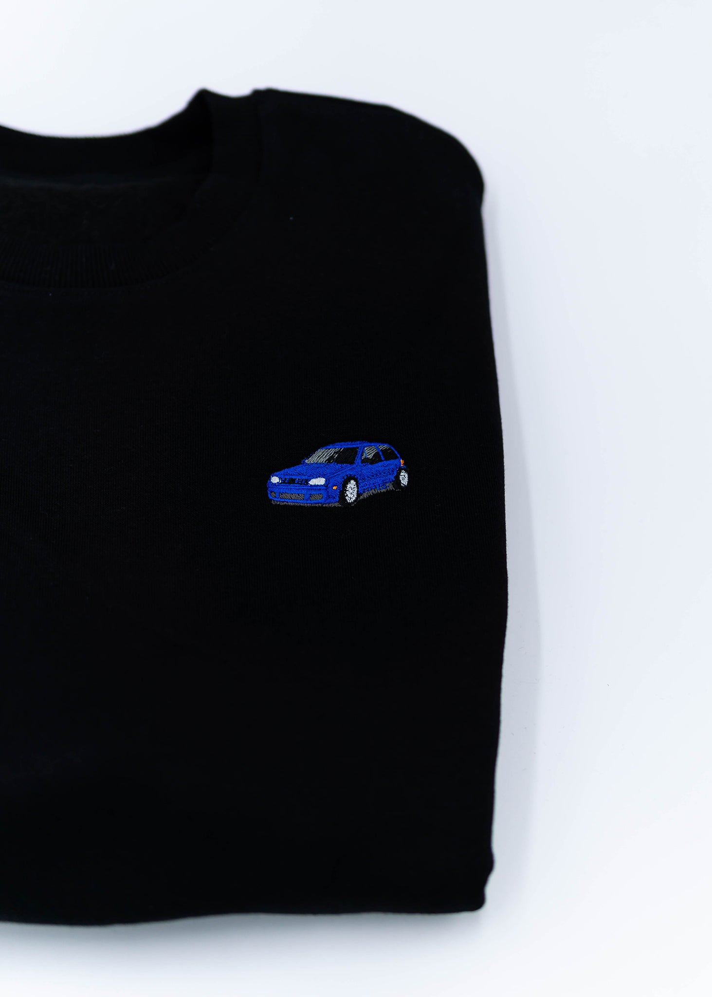 A black Mk4 Golf R32 crewneck sweater for men. Photo is a close up of the sweater with an embroidered Mk4 Golf R32. Fabric is a cotton and polyester mix and high quality and fits to size. The style is long sleeve, crew neck, and embroidery on left chest.